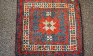 Hand knotted wool on wool small table mat from Bergama, approximately 30 years old