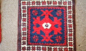 Hand knotted wool on wool small table mat from Bergama, approximately 30 years old